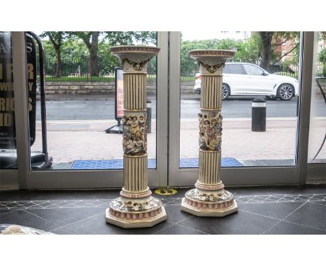 Pair of Tall Ceramic Jardinieres, decorated with gilt highlights and figures and cherubs.  Measure 36" tall. 