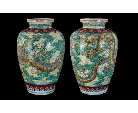 A Pair of Early 20th Century Japanese Ceramic Vases, Depicting Dragons Flying Amidst Stylised Clouds and Vapours on a Famille
