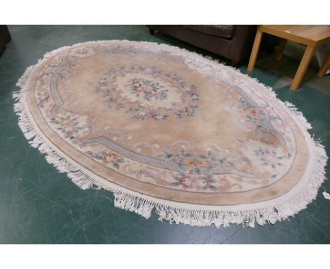 Large oval shaped floral fringed rug