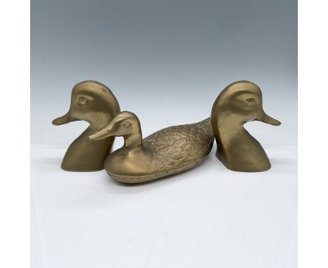 A set of three brass decorative pieces, including two duck head bookends measuring 4.75"H each and a duck figurine measuring 