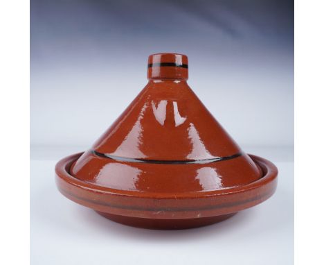 Moroccan-style ceramic tagine featuring a glazed terracotta finish with decorative black stripes. The conical lid and shallow