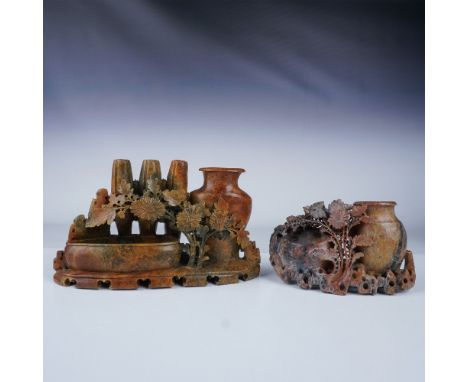 This pair of Chinese carved soapstone vases showcases exquisite craftsmanship and attention to detail. The first piece featur