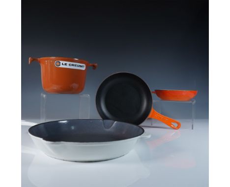 This 4-piece Le Creuset cast iron cookware set features enameled cast iron construction in iconic flame orange and white fini