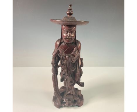 A finely hand-carved wooden figure depicting a Chinese priest. The statue is intricately detailed, showcasing flowing robes, 