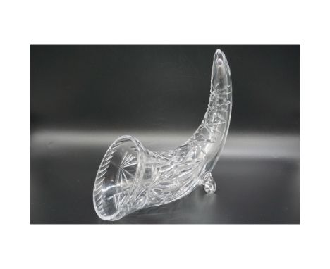 This exquisite cut glass vase is elegantly shaped like a cornucopia, featuring intricate diamond and fan cuts that enhance it