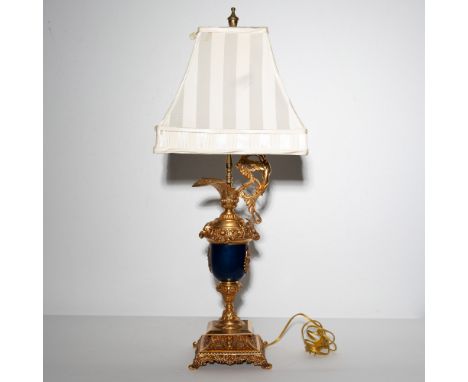 An exquisite table lamp featuring a striking combination of gilded accents and deep blue elements, designed in an elegant neo