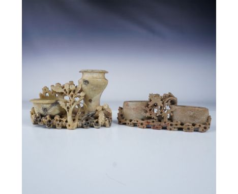 This pair of intricately carved Chinese soapstone vases showcases fine craftsmanship. Each piece features detailed floral des