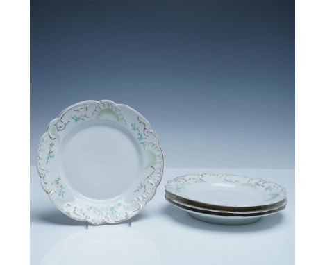 A set of four finely crafted German porcelain plates, each measuring 8"Dia and featuring an elegant hand-painted floral and g