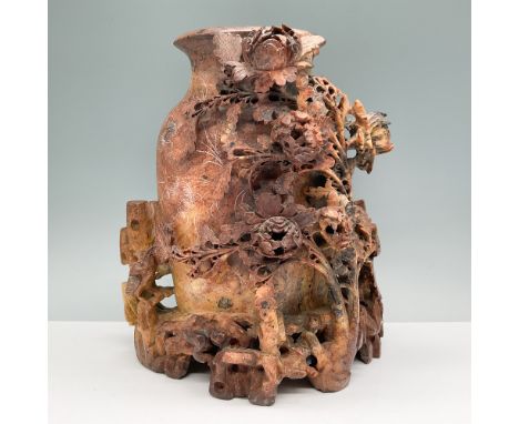 Intricately hand-carved stone vase featuring a detailed floral relief with finely sculpted roses and foliage. The vase showca