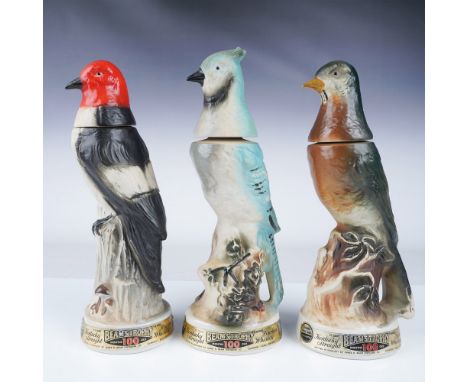 A set of three Beam's Trophy decanters, each designed as a bird and hand-painted in fine detail. These ceramic decanters were