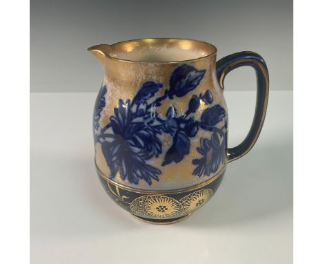 A charming Royal Doulton small porcelain pitcher, beautifully adorned with hand painted blue daisy-like flowers and enhanced 