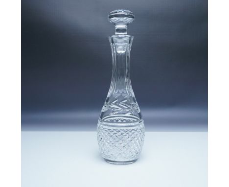 An elegant cut crystal wine decanter featuring a gracefully elongated neck and intricate diamond and fan-cut patterns along t