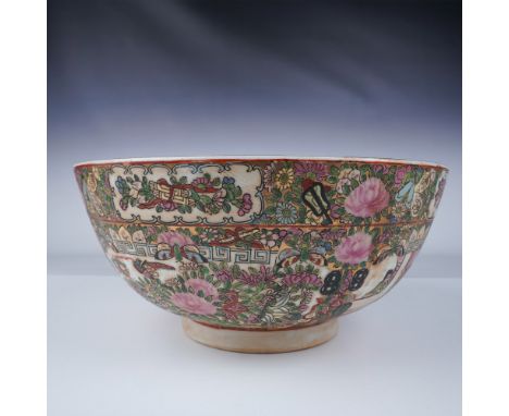 This vibrant Chinese porcelain bowl features a Famille Rose design, characterized by intricate floral patterns and figural sc