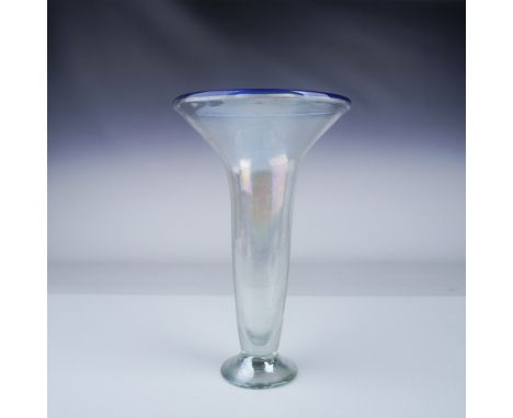 A striking hand blown studio art glass vase featuring a clear lustre finish and an elegant blue trim around the flared rim. T