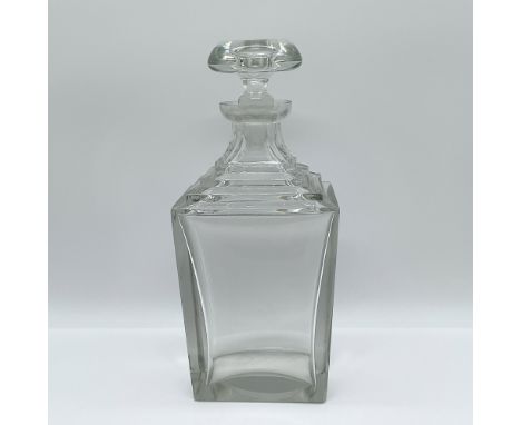 This elegant cut glass decanter features a stepped geometric design, showcasing a sleek and symmetrical aesthetic. Standing 1
