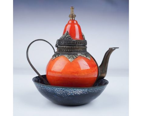 This charming 2-piece set features a miniature Nepalese enameled metal teapot with vibrant orange red enamel and intricate me