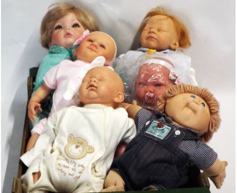 A collection of five mostly soft bodied dolls including reborn doll and also a cabbage patch doll