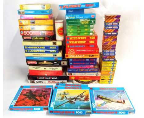 Two boxes containing a large selection of vintage jigsaw puzzles, including World War 2 aircraft, Thelwell, Wild West, Railwa