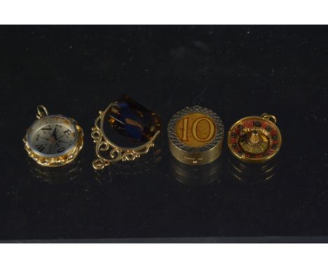 Four 9ct gold charms including roulette wheel, compass etc, total weight approx 16g