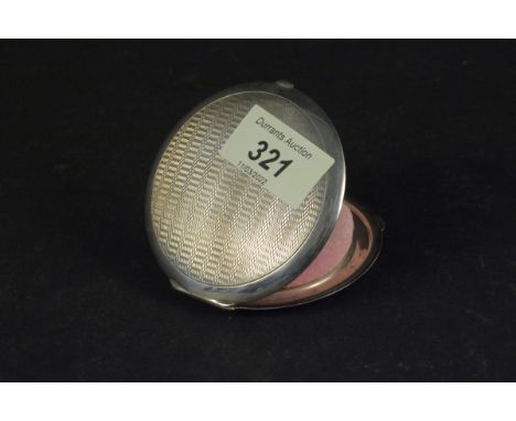 A silver compact with engine turned decoration, hallmarked Birmingham 1936