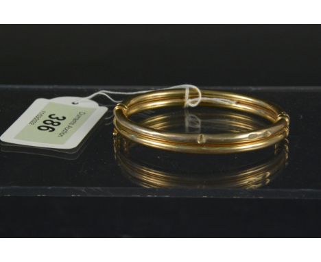 A 9ct gold double row hollow bangle, weight approx 10g (dented)