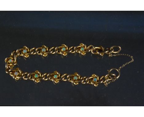 A 9ct gold bracelet made up of interlocking oval links set with eleven small opal stones (one damaged, clasp is a replacement