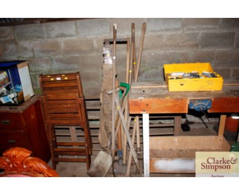 A collection of long handled gardening tools