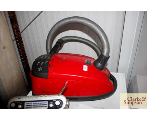 A Miele vacuum cleaner with instruction manual