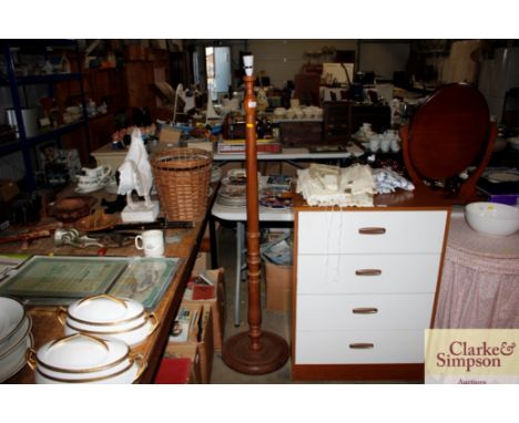 A teak standard lamp lacking shade