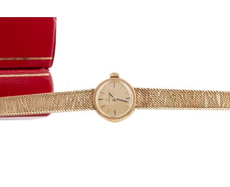LADY'S OMEGA NINE CARAT GOLD MANUAL WIND WRIST WATCH,the round champagne dial with baton hour markers, 16mm case, on an integ
