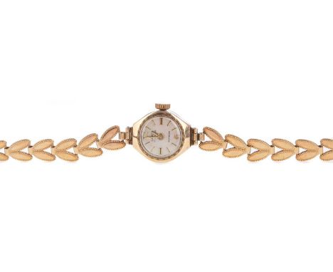 LADY'S LANCO NINE CARAT GOLD MANUAL WIND WRIST WATCH,the round cream dial with baton hour markers, 14mm case, on a nine carat