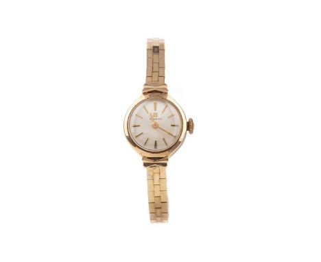 LADY'S TISSOT NINE CARAT GOLD MANUAL WIND WRIST WATCH,the round cream dial with baton hour markers, 15mm case, on a nine cara