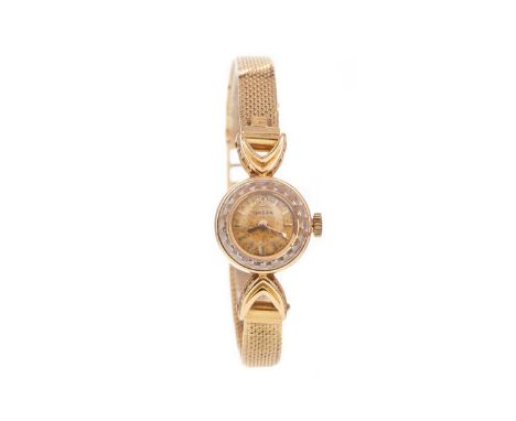 LADY'S OMEGA EIGHTEEN CARAT GOLD MANUAL WIND WRIST WATCH,the round champagne dial with baton hour markers, 15mm case, on an e