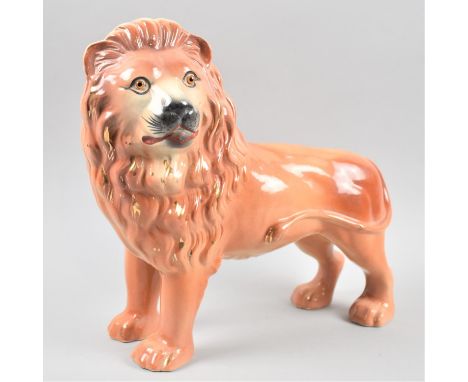 A Late 19th/Early 20th Century Ceramic Study of a Standing Lion, with Glass Eyes, 31cm Wide 