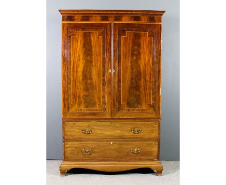 A late Georgian gentleman's mahogany wardrobe inlaid with stringings and cross bandings, the upper part with moulded cornice,