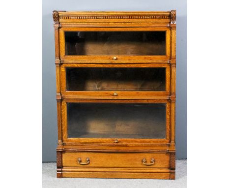 An early 20th Century Globe Wernicke panelled oak three-tier bookcase, the upper tier with moulded and dentil cornice, with c