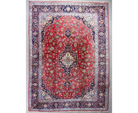 A good Kashan carpet woven in colours with a central floral filled medallion and conforming spandrels, field filled with trai