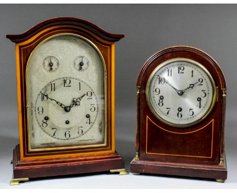 An early 20th Century German stained as mahogany cased mantel clock, the 7.5ins arched silvered dial with Arabic numerals and