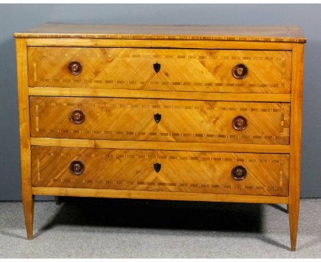 A late 18th/early 19th Century Continental fruitwood commode in the "Biedermeier" style, the top and drawer fronts inlaid wit