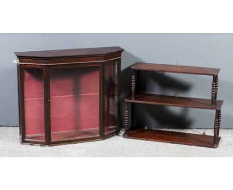 A mahogany three tier open front wall shelf with rounded front corners, reeded edge to each tier, on slender bobbin turned su