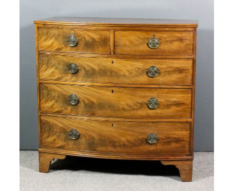 A late George III mahogany bow-front chest with twin reeded edge to top, fitted two short and three long drawers, with figure