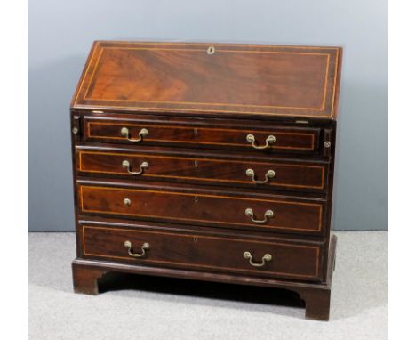 A Edwardian mahogany bureau inlaid with stringings and crossbanded with rosewood, the slope enclosing pigeon-holes, six small