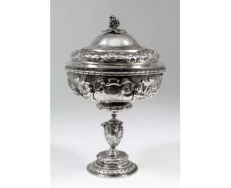 A Victorian Regimental silver gilt cup and cover of Mannerist design, the whole cast with scroll strapwork, cartouche Putti a