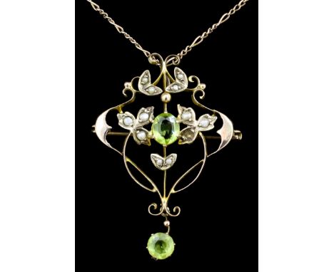 An Edwardian 9ct gold seed pearl and peridot set pendant or brooch at will, the scrolling face set with two peridot within bo