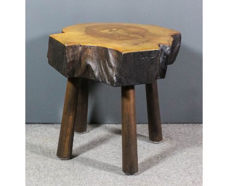 A polished tree trunk occasional table of shaped outline, on three turned supports, 26ins x 28ins x 26ins high