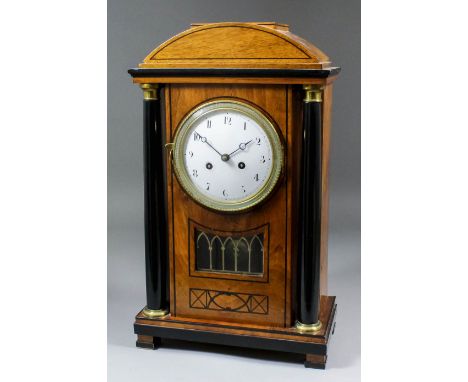 An early 19th Century Continental walnut and ebonised mantel clock in the "Biedermeier" style, the 4.25ins diameter white ena