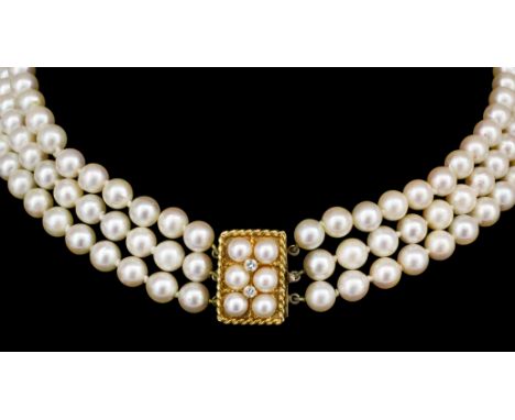 A modern three strand cultured pearl necklace, 340mm overall, with rectangular 9ct gold pearl and diamond set clasp, (gross w
