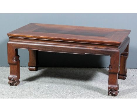 A Chinese rosewood "opium" table with flush panelled top, slightly moulded rails and on square moulded legs with scroll feet,