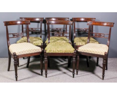 A set of six George IV mahogany dining chairs, the narrow curved crest rails with carved leaf ornament, with reeded uprights,