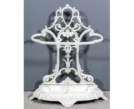 A white painted cast iron stick/umbrella stand, the back pierced and cast with vase of flowers and leaf scroll ornaments, on 